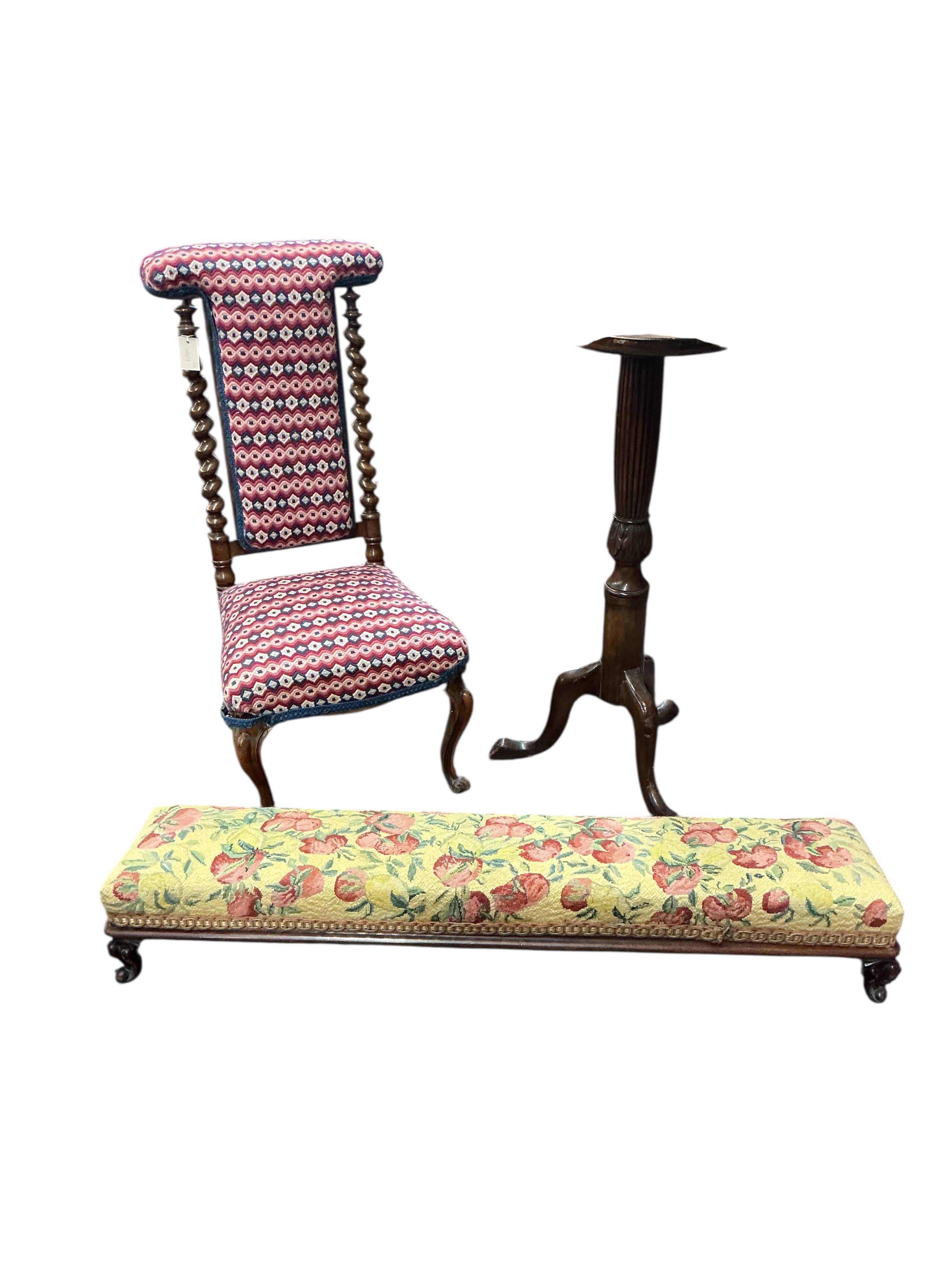 A Victorian upholstered walnut prie dieu chair, a Victorian fender stool and an Edwardian mahogany torchere